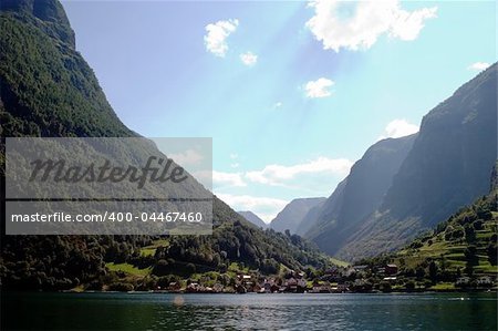 Fjord Scenic from the pass between Aurlandsfjord and naeroyfjord (nærøyfjord), in Sognefjord, Norway.  Blue sky and sun with lens flare.