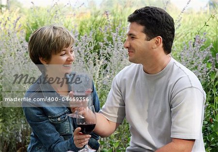 Young couple having picnic with wine