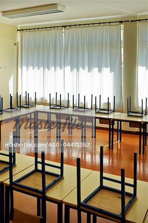 Schoolroom interior with chairs upside-down