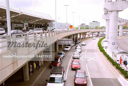 Travelers getting taxis at arrival area of airport