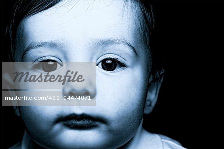 baby portrait over black background blue tone