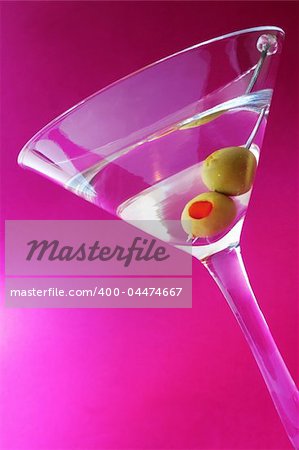 Martini cocktail with twoolives and mauve background