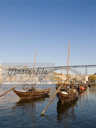 Cityscape with a typical porto wine rebelo boat in the foreground