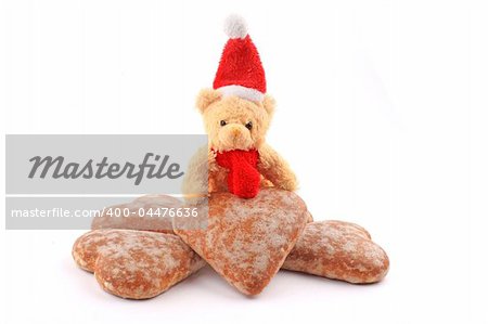 Santa teddy bear on pile of honey-cakes hearts