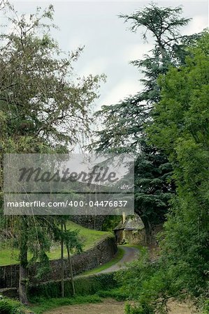 Road following the moat of a medieval Perigord castle.