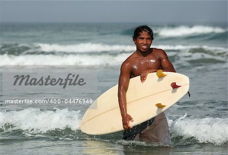 Portrait young men - the surfer in ocean. Bali