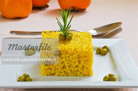 spanish and mediterranean yellow rice style on white platter