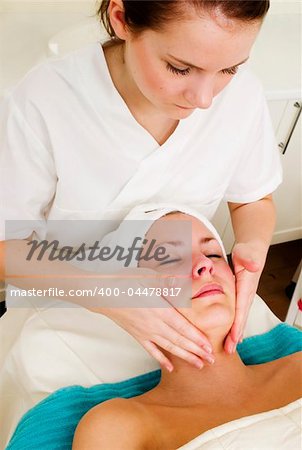 A face massage during a facial at a beauty spa.