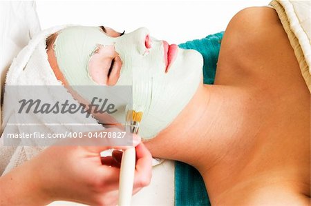 A detail image of a green apple mask being applied at a beauty spa.