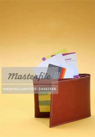 Brown leather wallet isolated on yellow