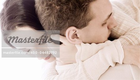 Studio portrait of a young couple cuddling