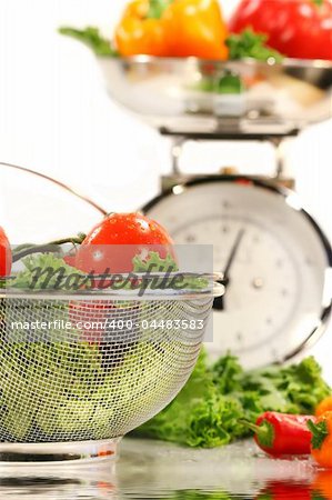 Vegetables, food basket and kitchen scale with water reflection