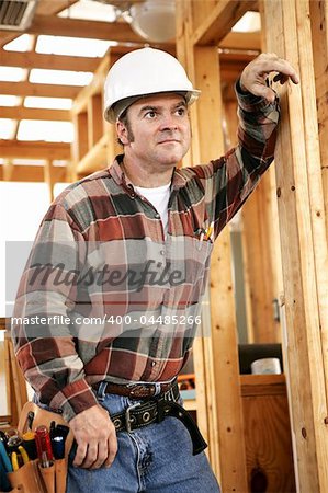 A construction worker looking into the distance with a thoughtful expression.