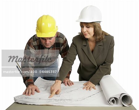 A female engineer going over the blueprints with a building contractor.  Isolated on white.