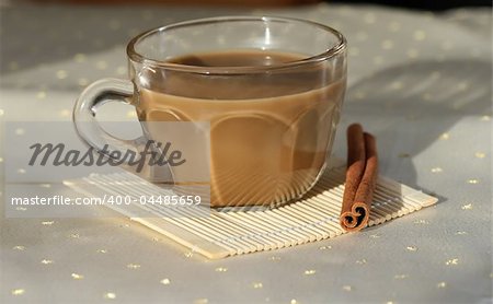 a cup of coffee with a cinnamon stick