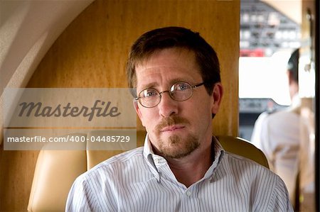 Business Executive Smiling on Plane