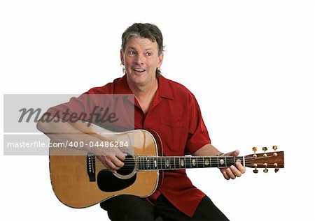 A handsome musician playing country music on his guitar.  Isolated.