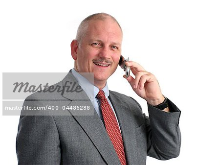 a happy businessman talking on his cell phone - isolated