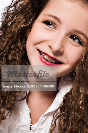 Studio portrait of a young girl with braces
