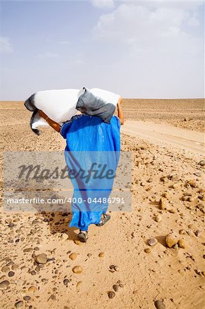 A woman walking through the desert.