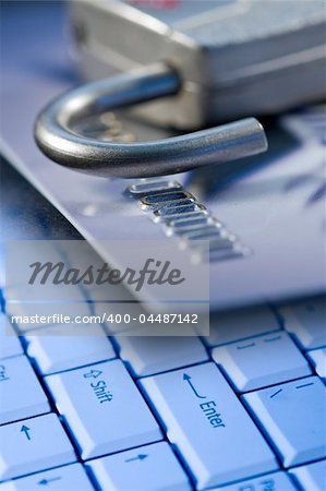 Credit card, lock, and a computer laptop keyboard for safety and security on the internet