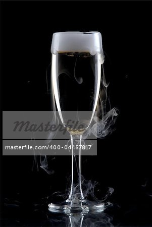 Glass of white wine isolated over black background, with smoke