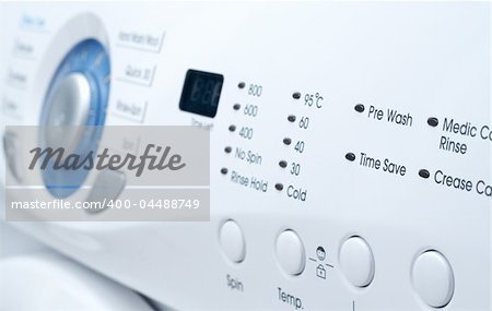 Closeup of a control panel of white washing machine