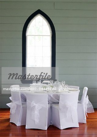 Tables decorated at a wedding reception held in a church hall.