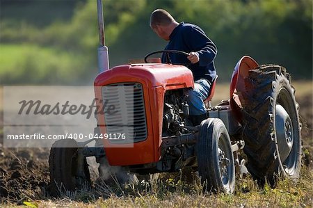 Old Tractor ploughing field