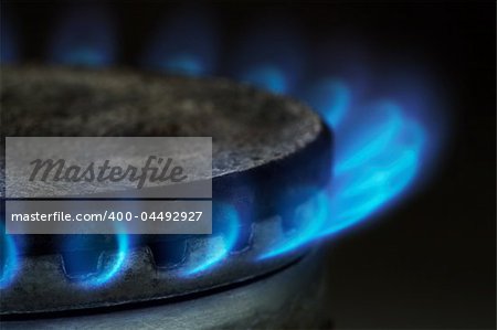 Gas burning by a dark blue flame on modern kitchen