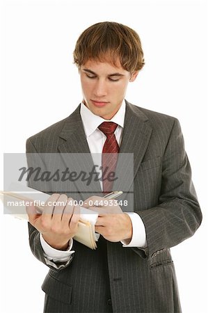 Handsome young businessman taking notes.  Isolated on white.