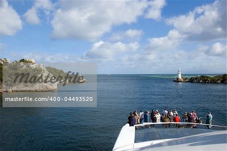 Tourists look out to the ocean on a cruise boat through the heads in Straughn, Tasmania.