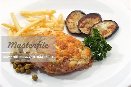 appetizing chicken fillet with green peas, fry potatoes and aubergine
