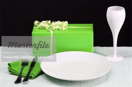 A dinner table set for a party in green