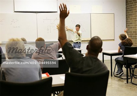 Adult education teacher in front of his class.