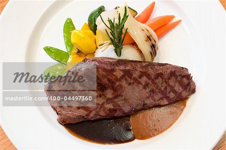 Juicy platter of beef steak served with mashed potatoes, carrots, beans and zucchini. Served with an assortment of sauces.