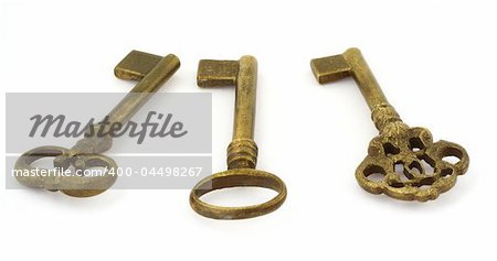 close-up of three various old keys isolated on white background
