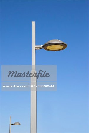 Picture of a modern street lantern with a blue sky in the background