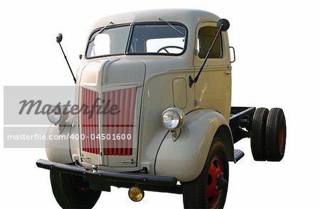 This is a picture of a 1940s cab-over tractor trailer truck without a trailer, taken at a low angle of the front corner. It has been cut-out and isolated with a white background.