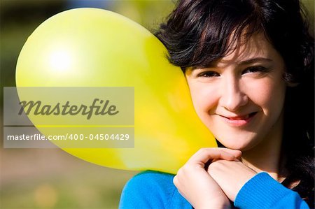 Cute girl with yellow colored balloon