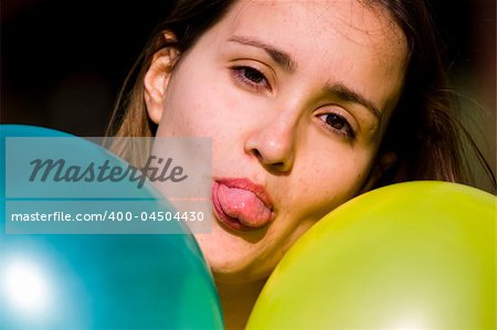 Cute girl between two colored balloons