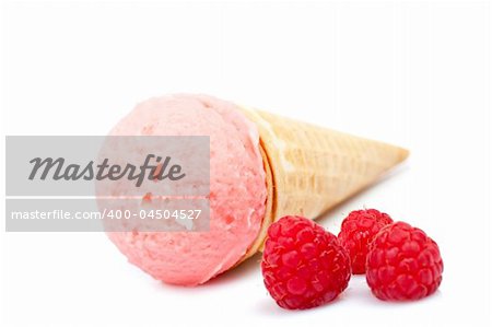 Delicious strawberry ice cream cone with raspberries. Soft shadow on white background. Shallow DOF