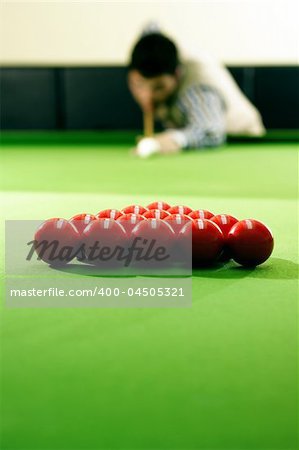 snooker player hitting a ball, shallow depth of field