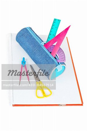 A blue pencil case with school supplies on a notebook