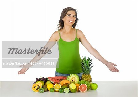 Beautiful and healthy woman with a lot of fruits in front of her