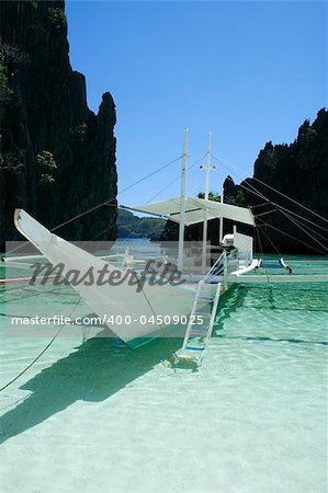 traditional banka outrigger in bacuit archipelago, el nido palawan island, in the philippines