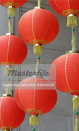Red chinese lanterns swinging in the breeze