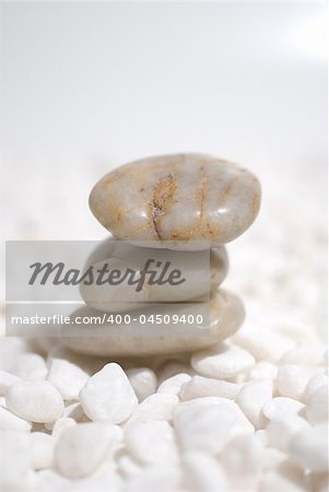 zen stones on white pebbles background - meditation concept