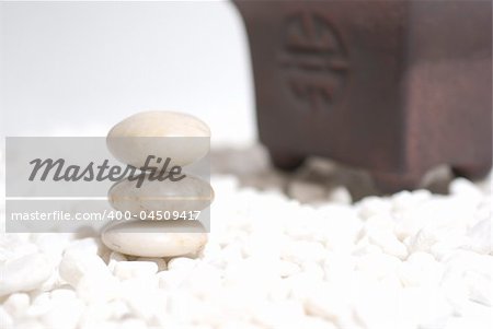 zen stones on white pebbles background - meditation concept