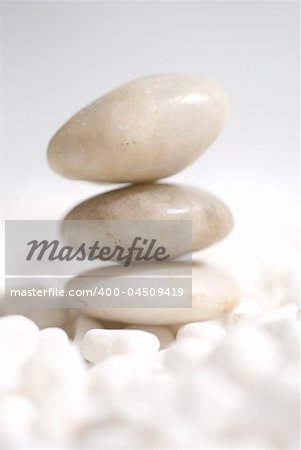 zen stones on white pebbles background - meditation concept